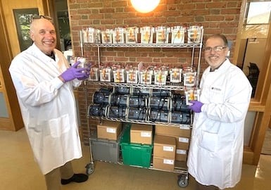 Cell Signaling Technology scientists stand in front of lab equipment to be donated to Seeding Labs